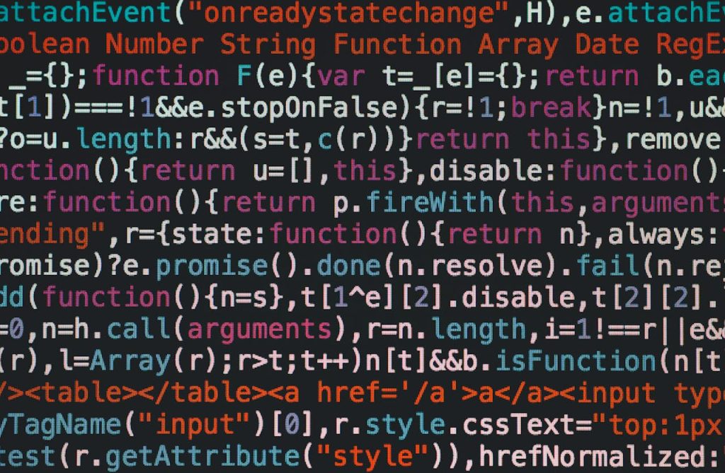 Close-up of colorful coding text on a dark computer screen, representing software development.