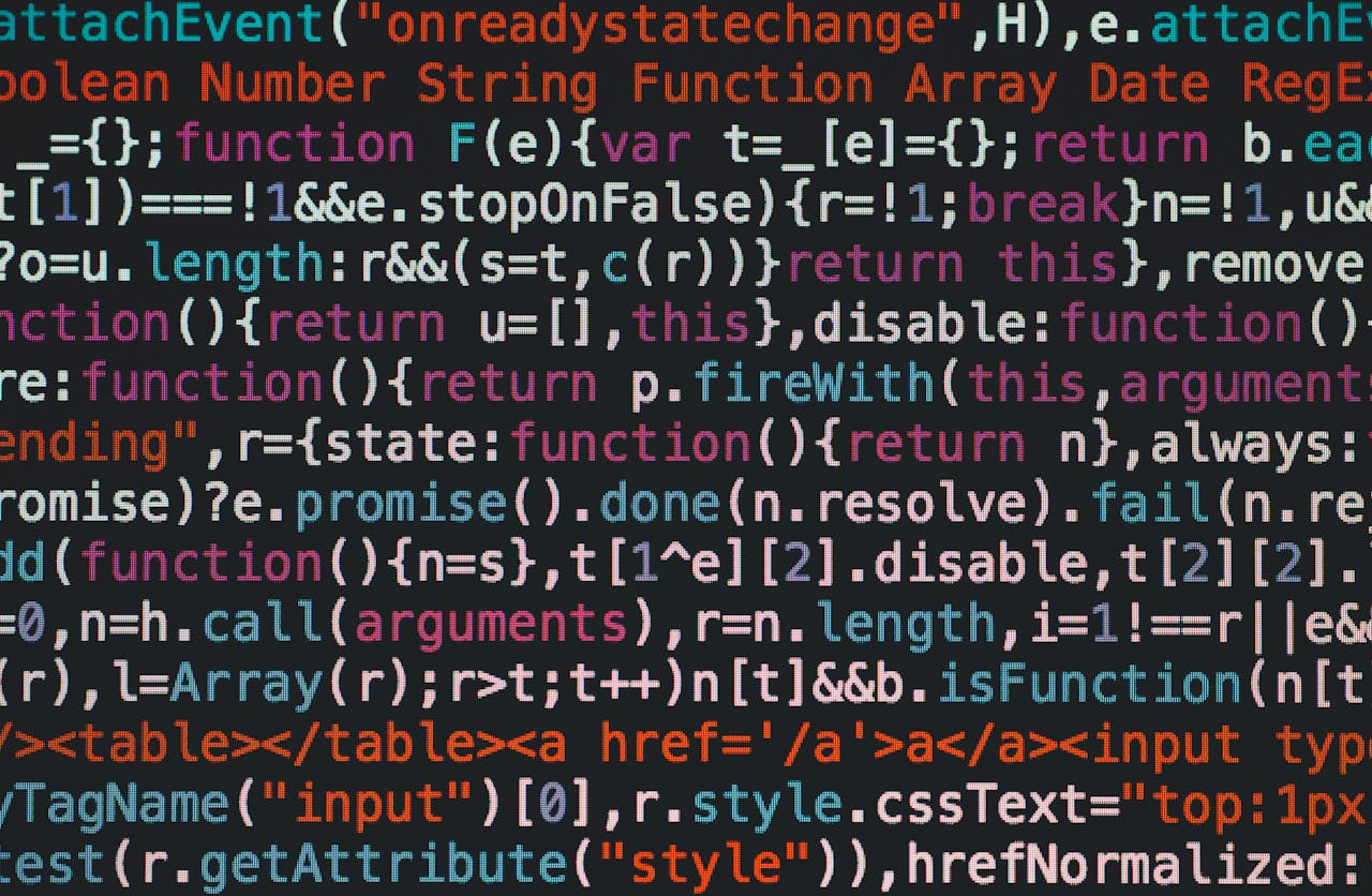 Close-up of colorful coding text on a dark computer screen, representing software development.